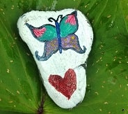 rock with a butterfly painted on it. And a love heart beneath the butterfly.